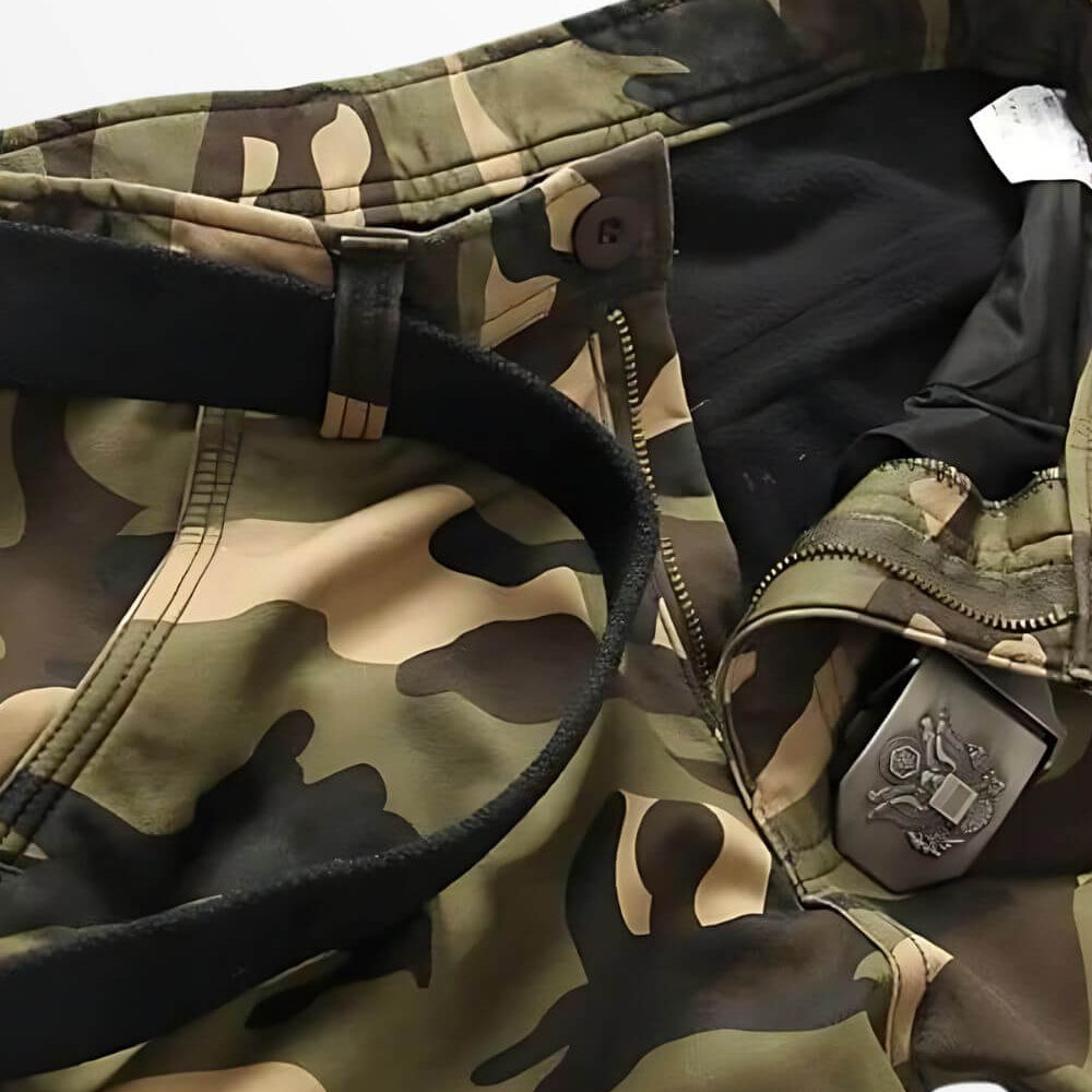 High-resolution image focusing on the zip fly area of men's cargo camouflage pants, displaying the quality of the material and camo pattern.