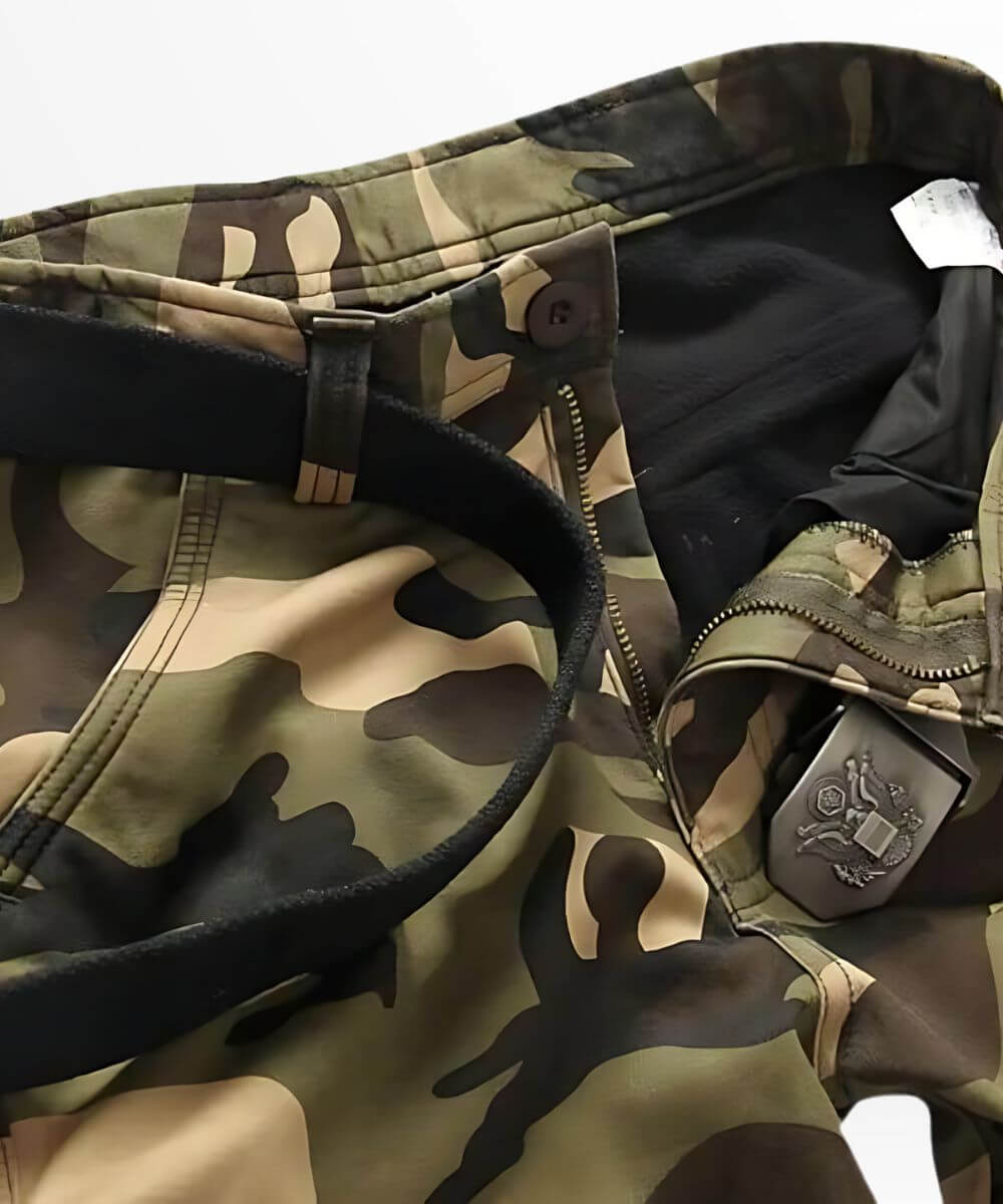 High-resolution image focusing on the zip fly area of men's cargo camouflage pants, displaying the quality of the material and camo pattern.