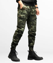 Close-up side view of military-style camo cargo pants showcasing the utility pocket details and rugged design.