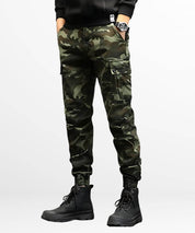 Full outfit featuring military-style camo cargo pants paired with a casual black top and sturdy combat boots.