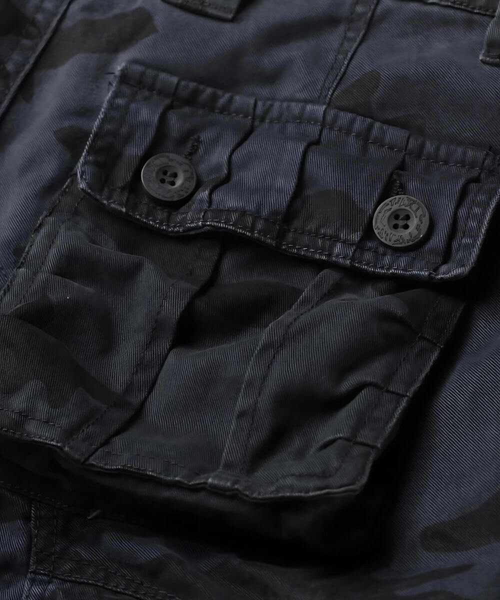 Detail of the cargo pocket on navy blue camo pants, emphasizing the utilitarian design.