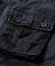 Detail of the cargo pocket on navy blue camo pants, emphasizing the utilitarian design.