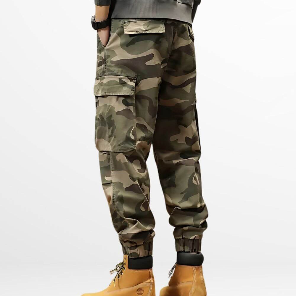Rear view of a person wearing green baggy camo cargo pants showing the fit and pocket detail.