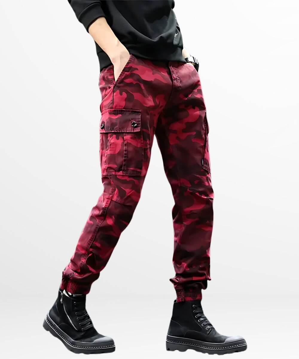 Man wearing red camouflage cargo pants with black boots, trendy look.