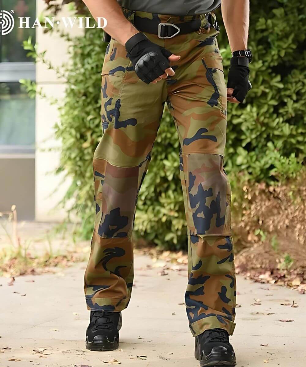 Man wearing jungle camouflage pants, styled for practical outdoor activities.