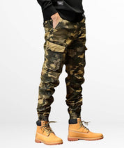 Side view of a person wearing khaki camo cargo jogger pants, accentuating the snug cuff design and utilitarian appeal of the pants.