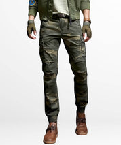 Front view of Slim Camo Cargo Pants Mens in a tactical style with gloves and brown boots.