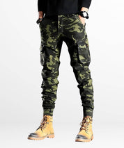 Full-length view of a male model in slim camo cargo pants, capturing the rugged outdoor aesthetic.
