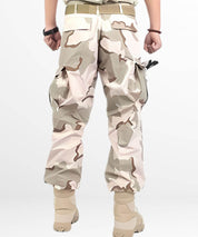 Relaxed fit sand camo cargo pants with spacious pockets and a tactical design, complemented by light-colored tactical boots.