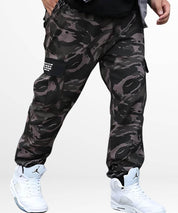Man wearing trendy baggy camouflage pants paired with high-top sneakers, posed to showcase the front fit and style.
