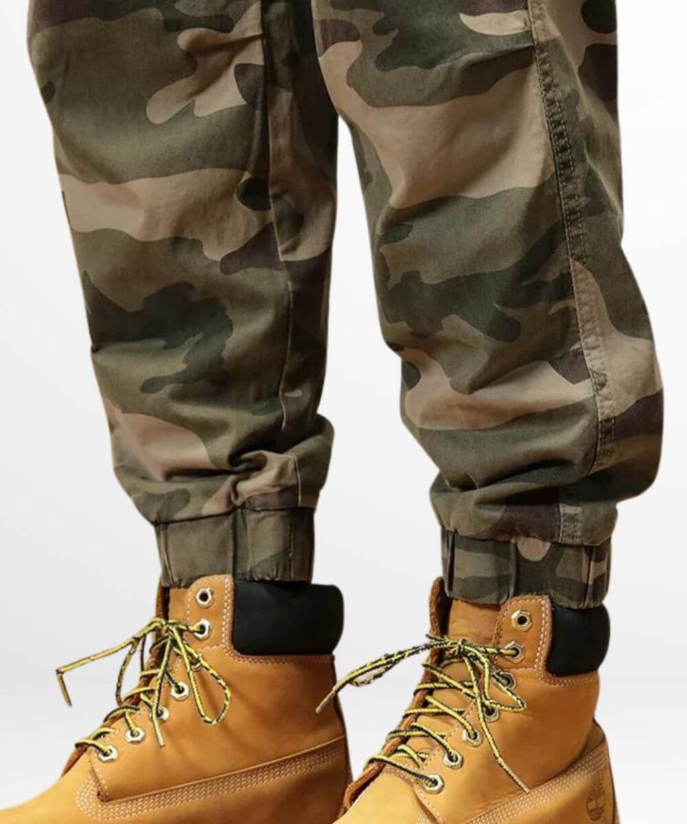 Green baggy camo cargo pants neatly tucked into honey-colored boots, showcasing a military-inspired style.