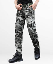 Urban style men's cargo pants featuring black and white camouflage print, showcasing a modern fit.