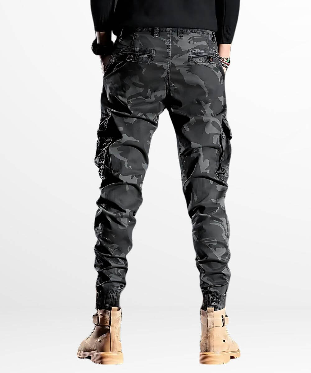 Back view of slim camo cargo pants in urban style, detailed with utility pockets and ribbed ankle cuffs.