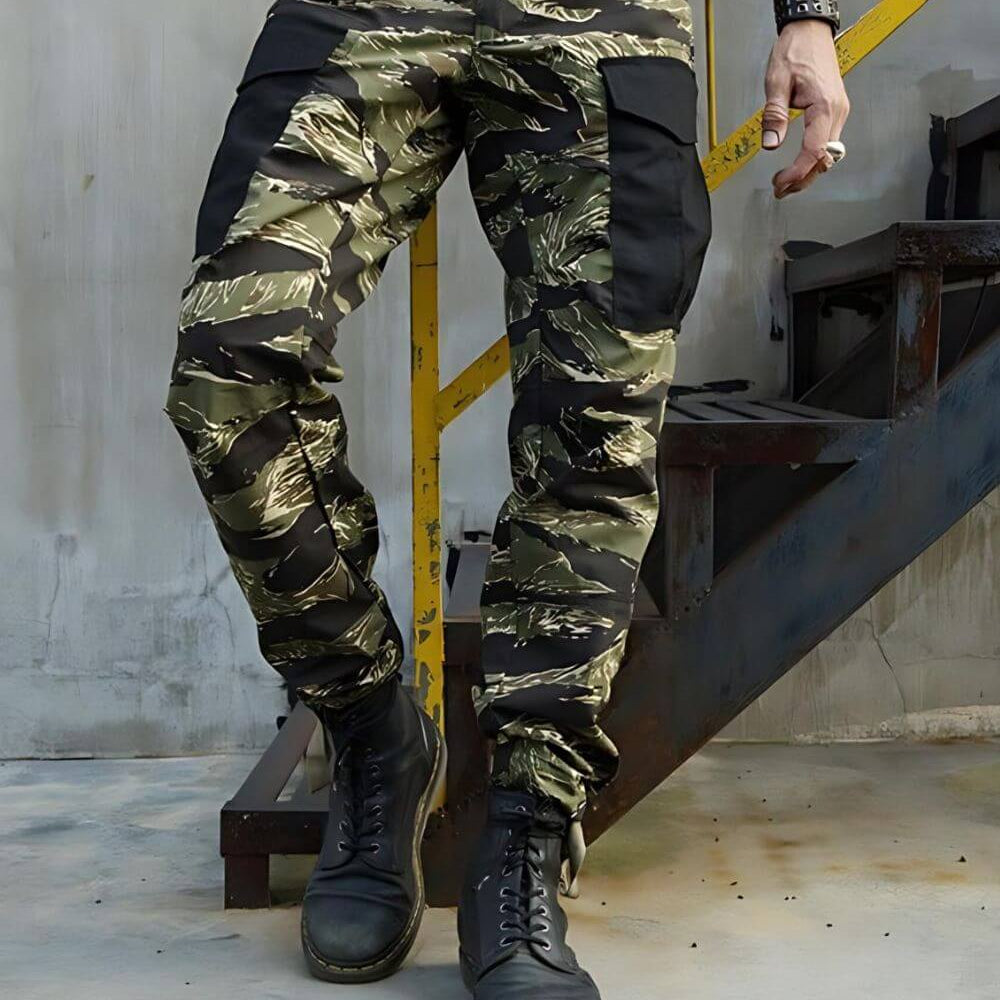 Full body standing pose in Vietnam Tiger Stripe camouflage pants paired with rugged black boots and a casual setting.