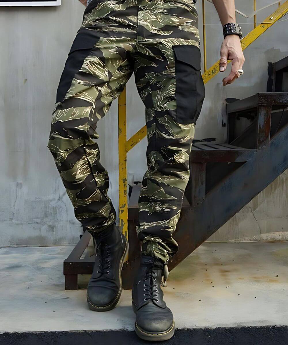 Full body standing pose in Vietnam Tiger Stripe camouflage pants paired with rugged black boots and a casual setting.