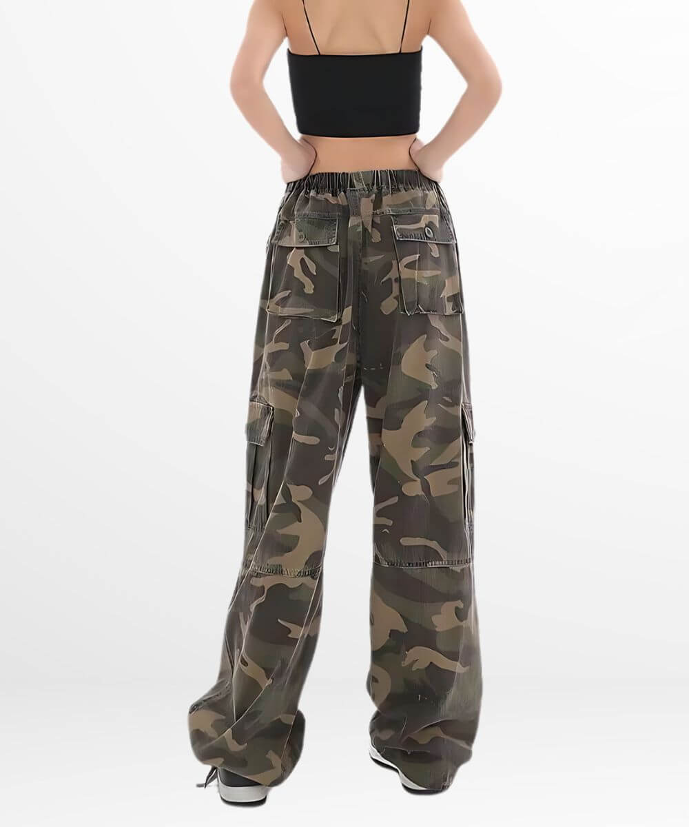 Back view of a woman wearing baggy camo pants, highlighting the loose fit and detailed back pockets.