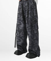 Full side view of women's baggy camouflage pants showing the spacious cargo pockets and wide leg design, complemented by sturdy black boots.
