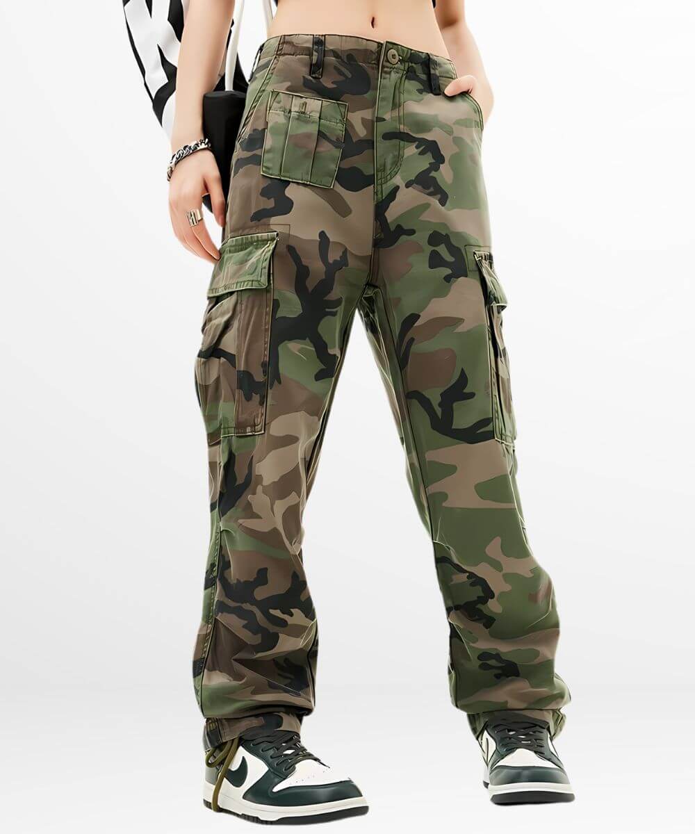 Close-up front view of women's green camouflage cargo pants featuring detailed pockets and paired with black and white sneakers.