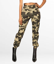 Front view of women's green camo cargo pants paired with stylish black ankle boots.