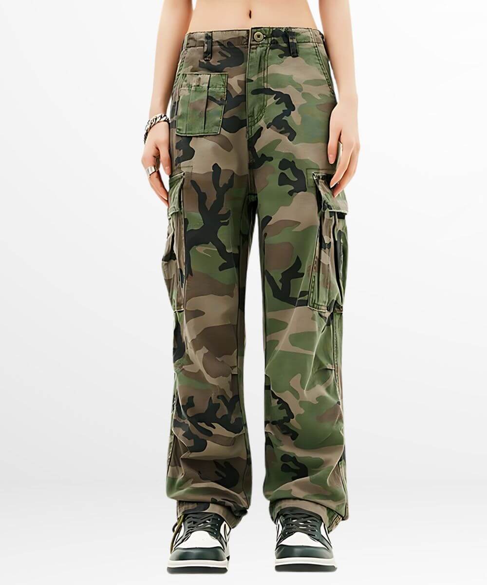 Full front view of women's green camouflage cargo pants with multiple pockets and stylish sneakers.