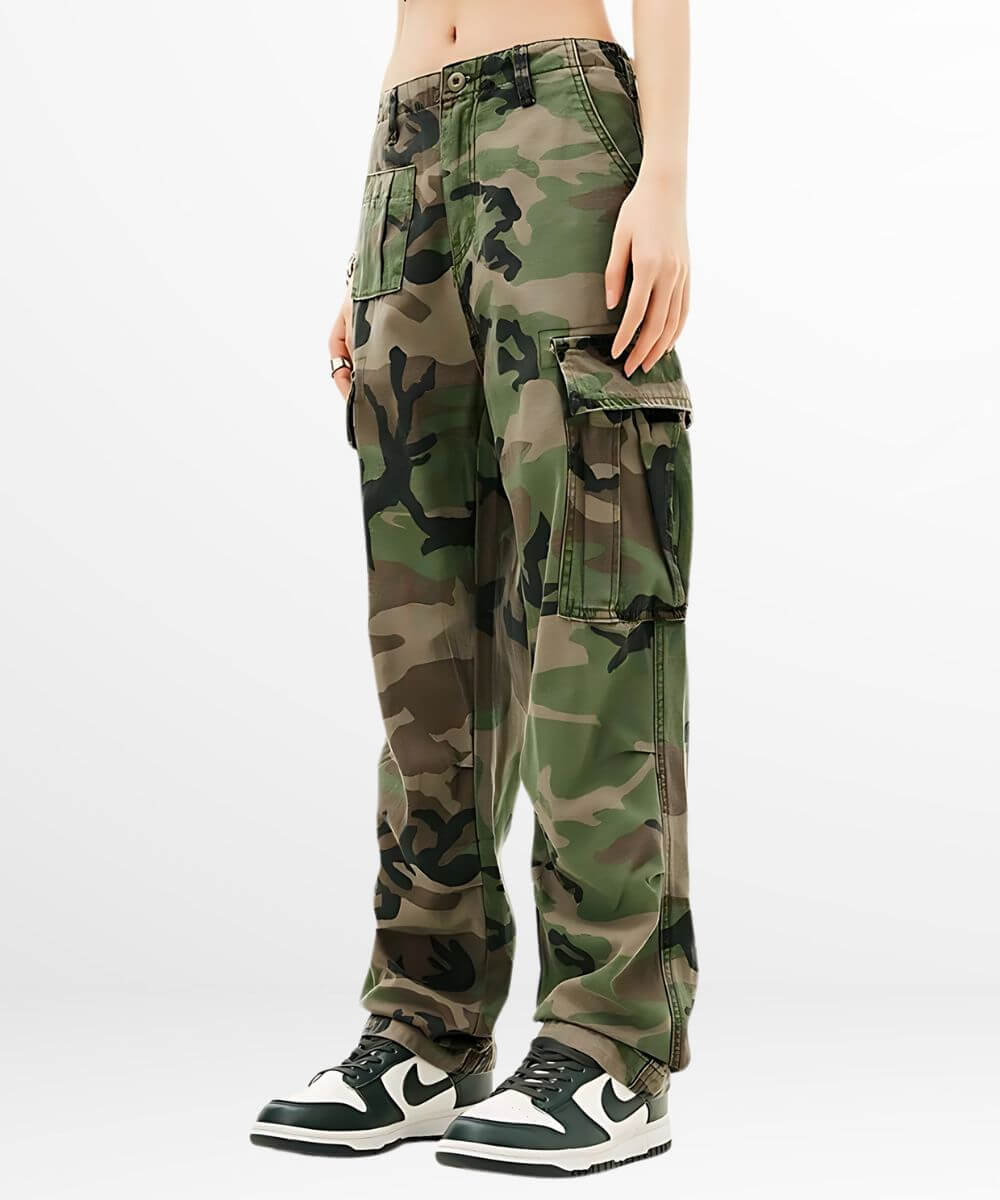 Side view of women's green camouflage cargo pants with cargo pocket details and trendy sneakers.