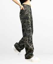 Woman walking in high-waisted camo cargo pants, showcasing the loose fit and stylish design with white sneakers.