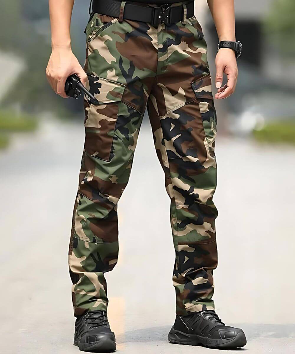 Front view focusing on the pocket details of woodland camo military cargo pants, emphasizing the storage capacity and robust design.